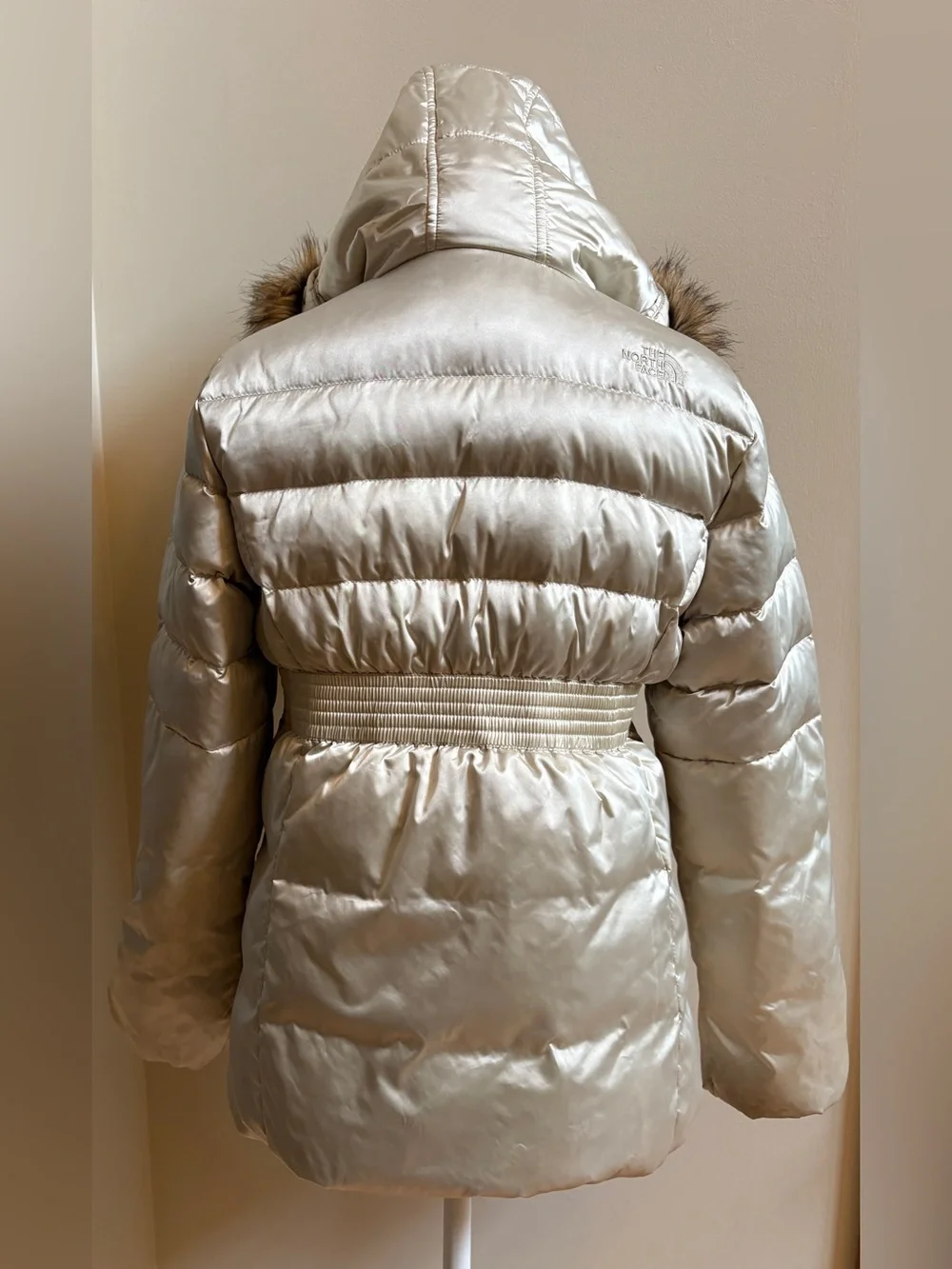 The North Face Girls champagne-colored puffer jacket